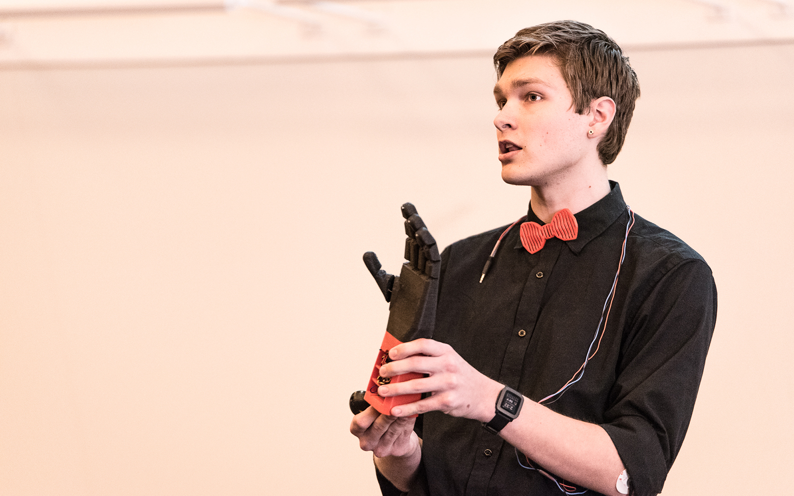 Stephen Hawes demonstrates the Atlas Arm: an inexpensive, 3D-printed prosthetic hand. (Nathan Oldham/UConn School of Business)