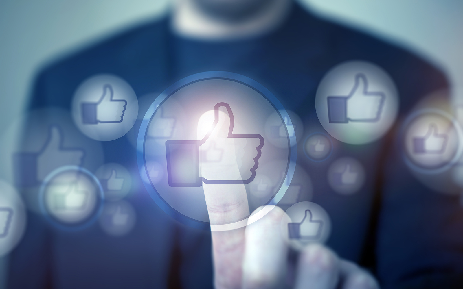 Social Media Likes and Social Marketing Concept with Businessman Touching Glowing Like Icon.
