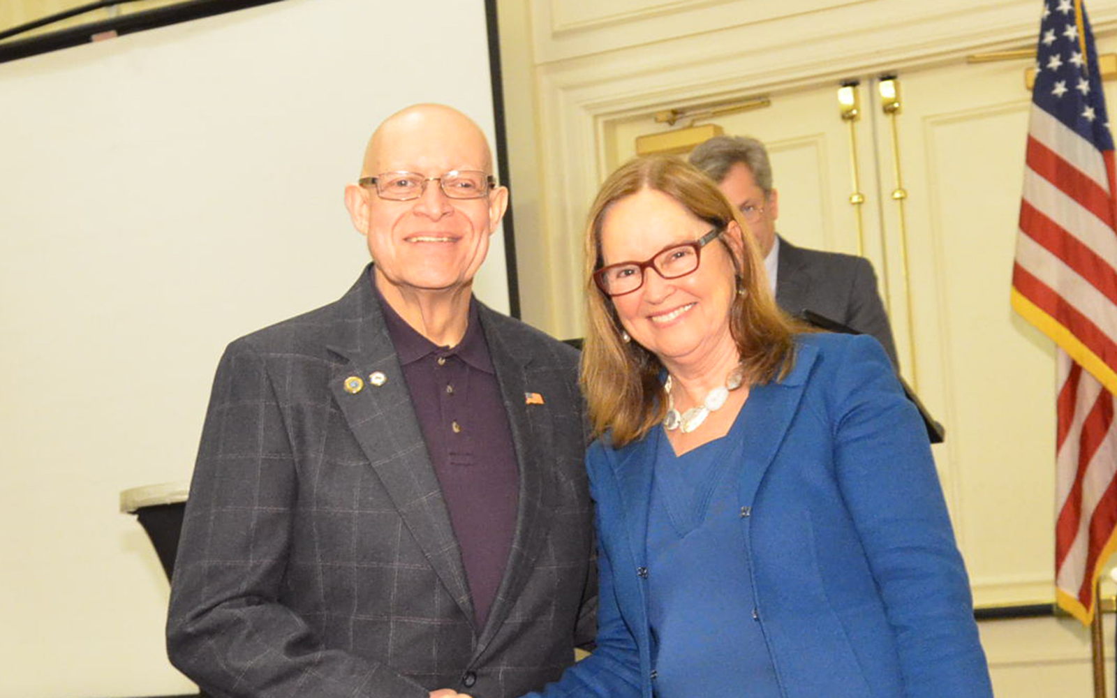 Paul Duarte, a registrar from Groton, shakes hands with Secretary of the State Denise Merrill at a ceremony at the Mystic Marriott Groton. (James Simon/UConn School of Business)