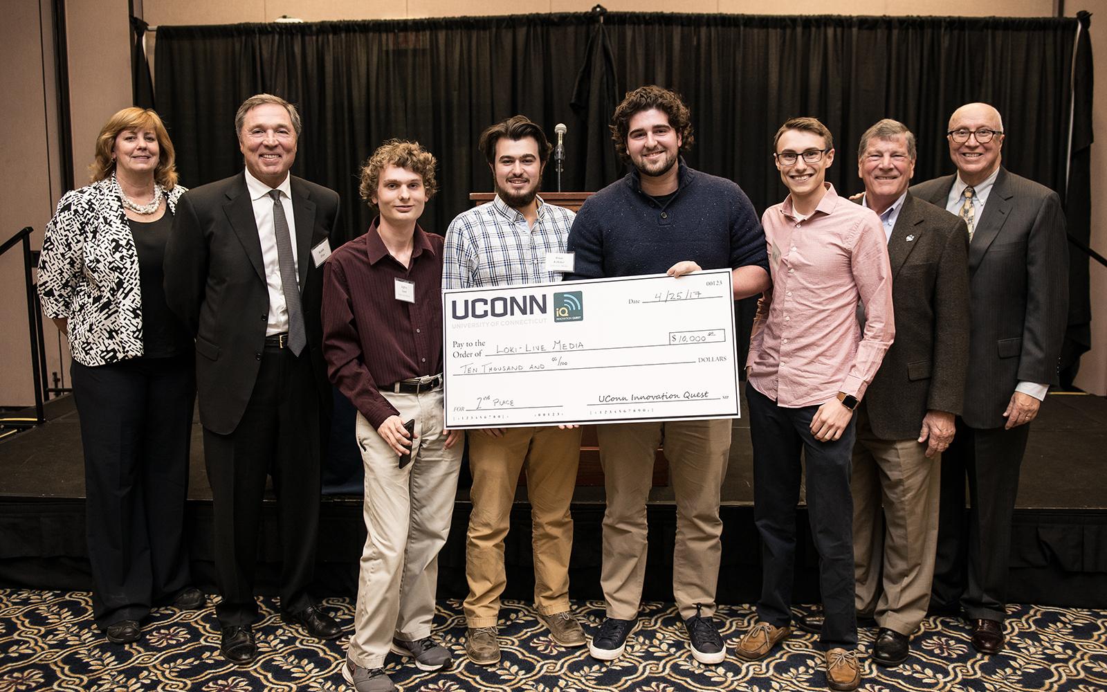 From left: Management Department Head Lucy Gilson, Alumnus Keith Fox ’80, LOKI team members Jeffrey Santi, Brian Kelleher, Andrew Ginzberg, and Case Polen; School of Business Dean John Elliott, and Management Professor Rich Dino (Nathan Oldham/UConn School of Business)