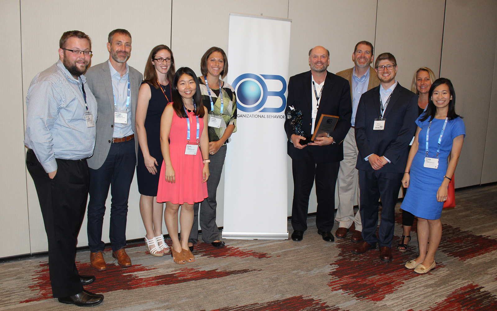 Mathieu receives his award from the Academy of Management, surrounded by past and present students. (John Mathieu/UConn School of Business)