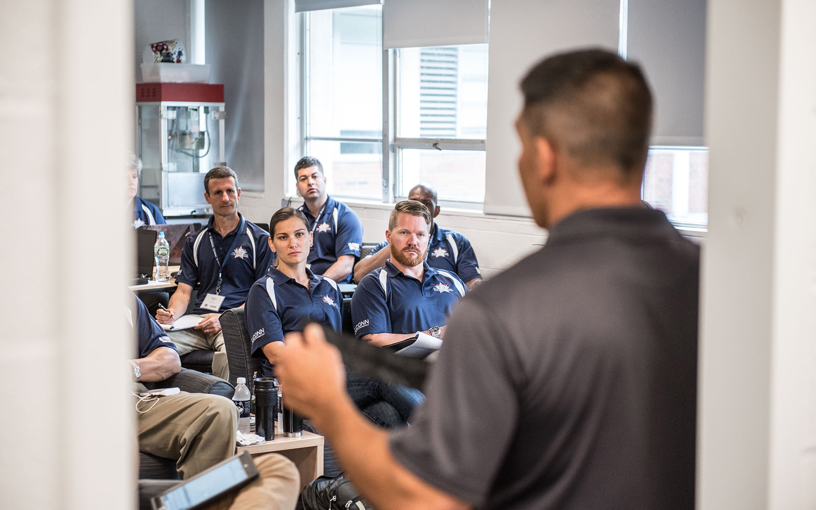 The EBV hosts up to 25 U.S. military veterans during an annual, 10-day program that prepares them to become entrepreneurs. Pictured above, EBV Class of 2017 veterans in class. (Nathan Oldham/UConn School of Business)