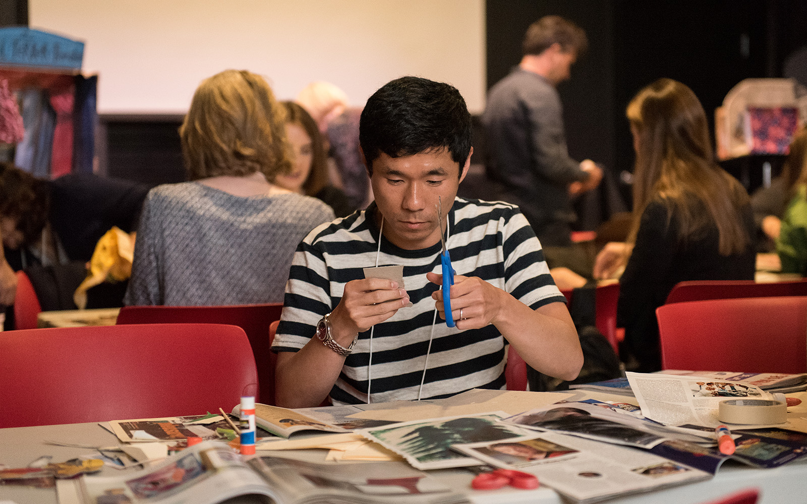 To spur creativity during the closing session, conference participants were given minimal resources such as old magazines and cardboard boxes, with which they created "toy theatres" at the Ballard Puppetry Museum. (Devin Basdekian/UConn School of Business)