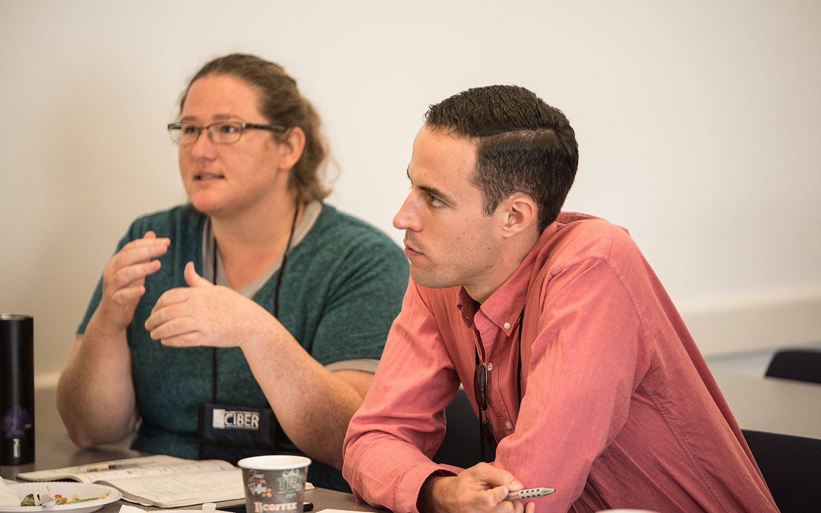 Jen Rhymer, a Ph.D. student at University of Washington, and her friend and co-author Alex Murray, a professor and chair of entrepreneurship at ETH Zurich, react to a discussion. Murray is a co-organizer of the symposium. (Nathan Oldham/UConn School of Business)