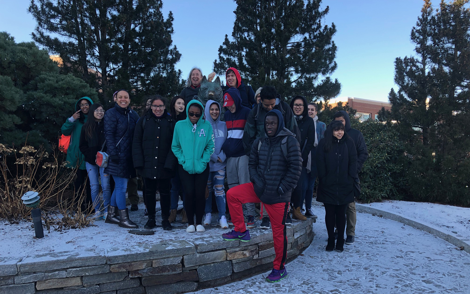 Students from Manchester High take a moment to pose with the statue of Jonathan outside of Gampel Pavilion during their recent visit to the Storrs campus.  (Arminda Kamphausen / UConn School of Business)