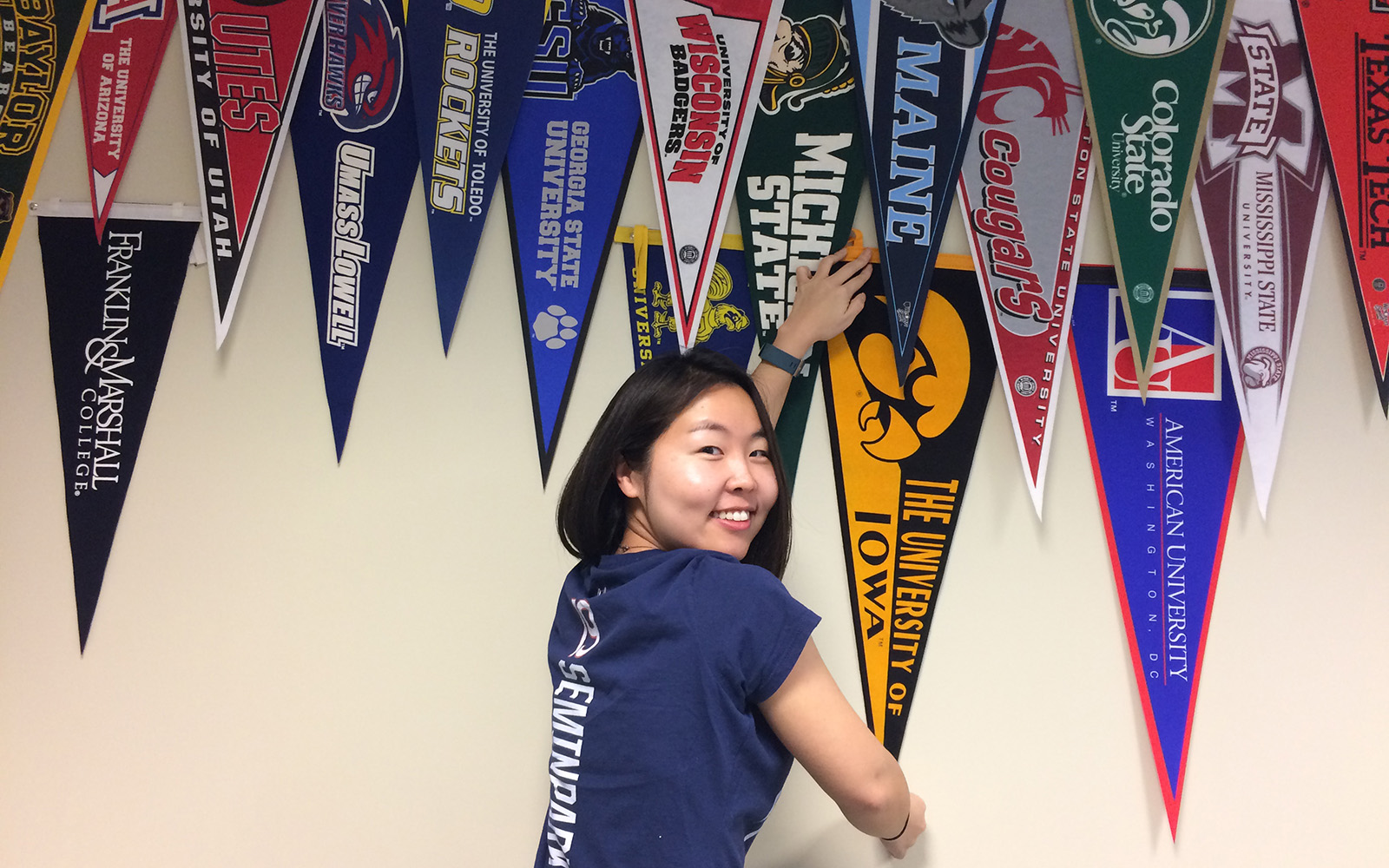 Semin Park pinning up the University of Iowa pennant.