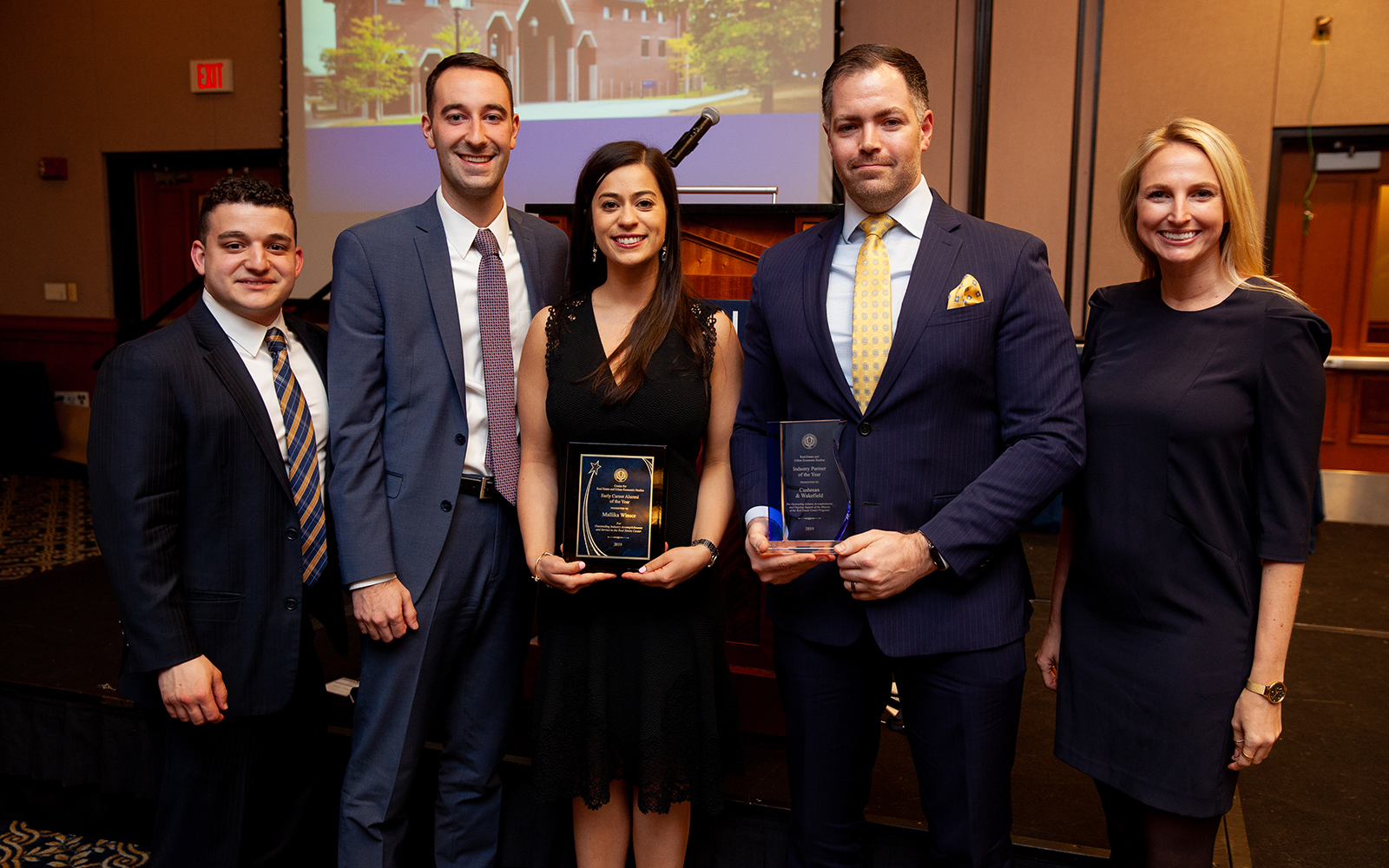 Mallika Winsor, Senior Associate at Cushman & Wakefield, is surrounded by colleagues during the Real Estate Center's annual banquet. (Zack Wussow)