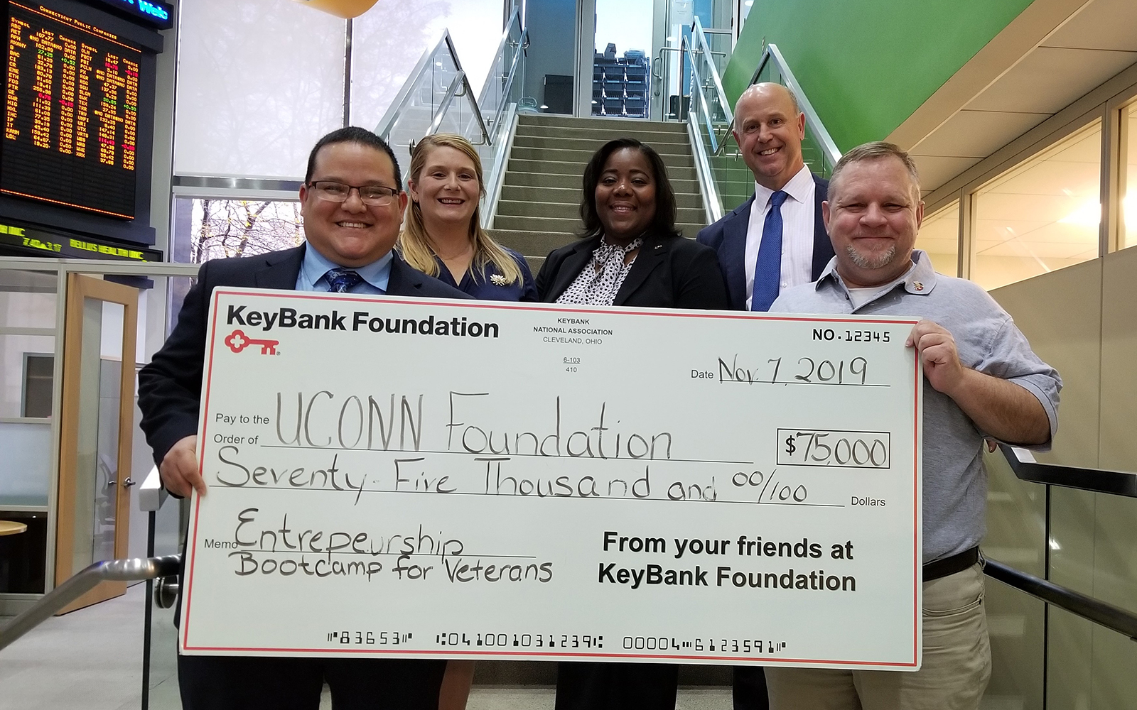 KeyBank has presented a $75,000 grant to the UConn School of Business’ Entrepreneurship Bootcamp for Veterans, which helps U.S. military veterans become small business owners. Pictured from left to right are UConn EBV program graduates Jorge and Jessica Rodriguez, KeyBank Corporate Responsibility Officer LaKisha Jordan, KeyBank Market President Jim Barger, and UConn EBV Director Michael Zacchea. (Contributed Photo)