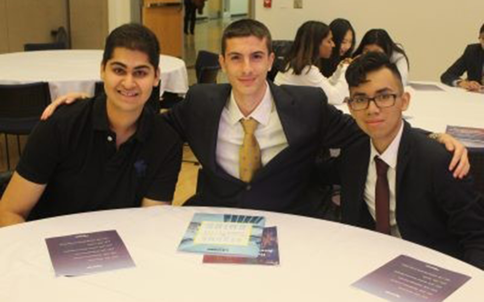 UConn Students pose at a conference table