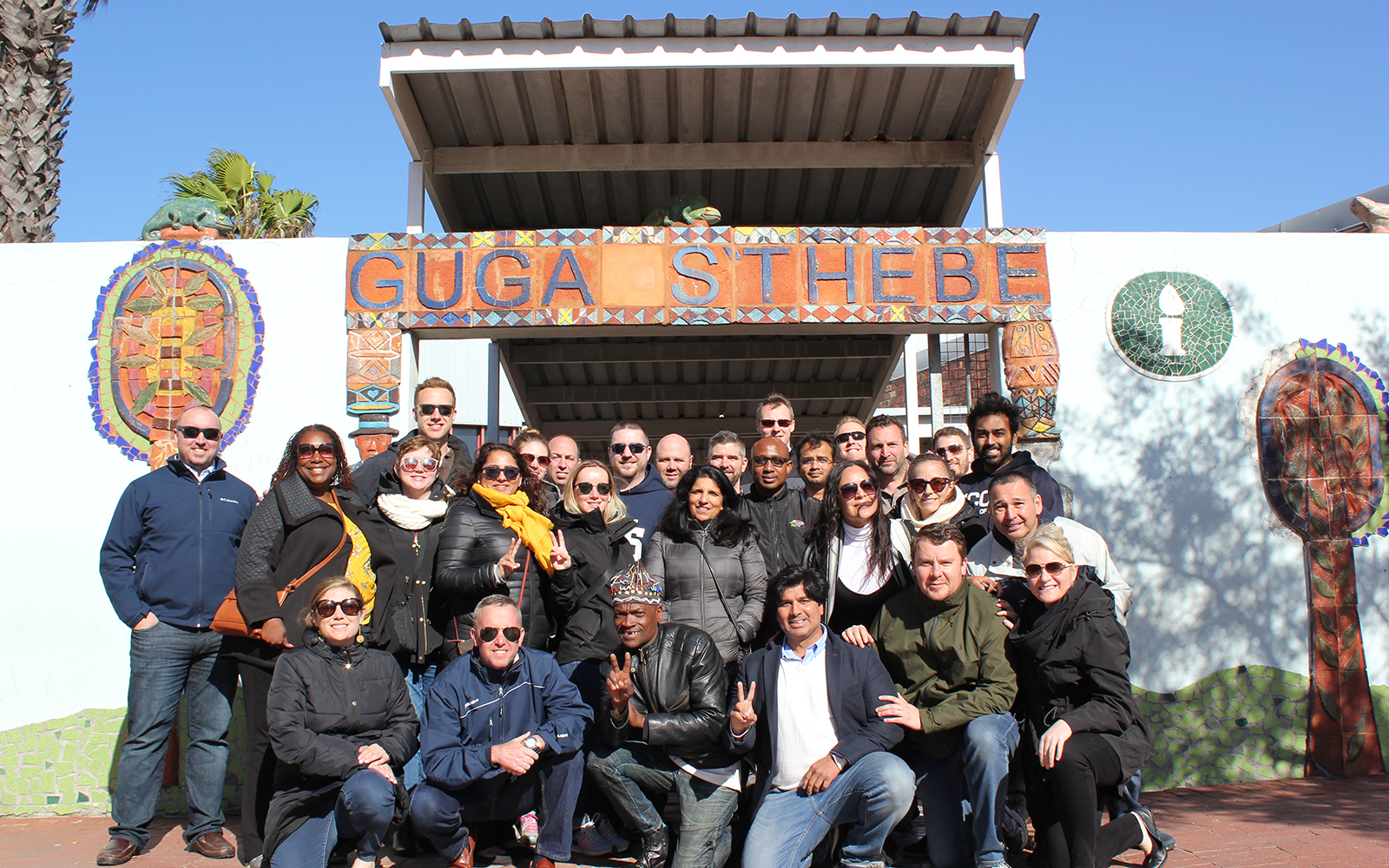 EMBA Class of 2020 join local guide Xolani Mapila at a community center in Langa Township within Cape Town.