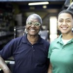 Portrait of mother and daughter working together in a paint store
