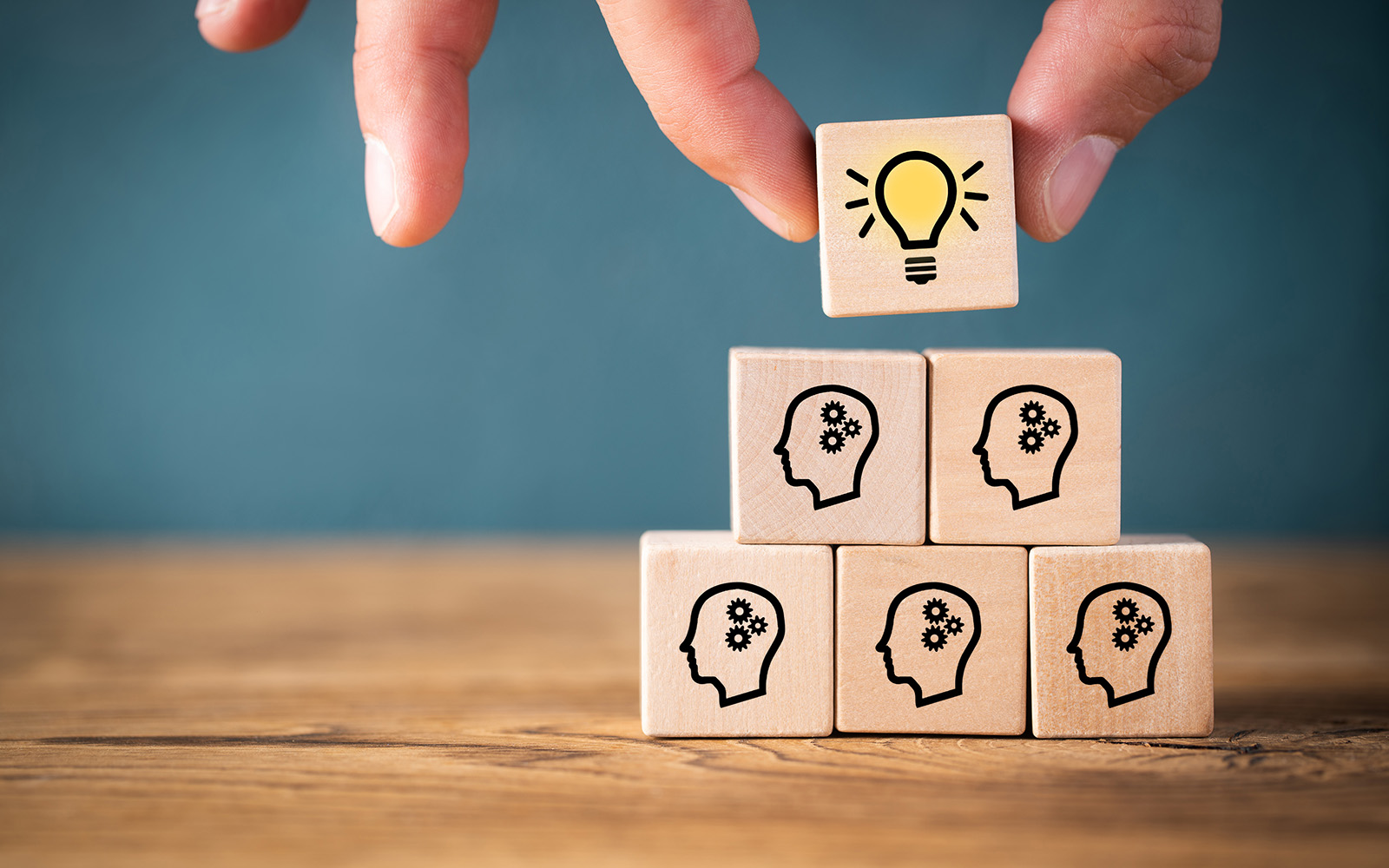 many people together having an idea symbolized by icons on cubes on wooden background