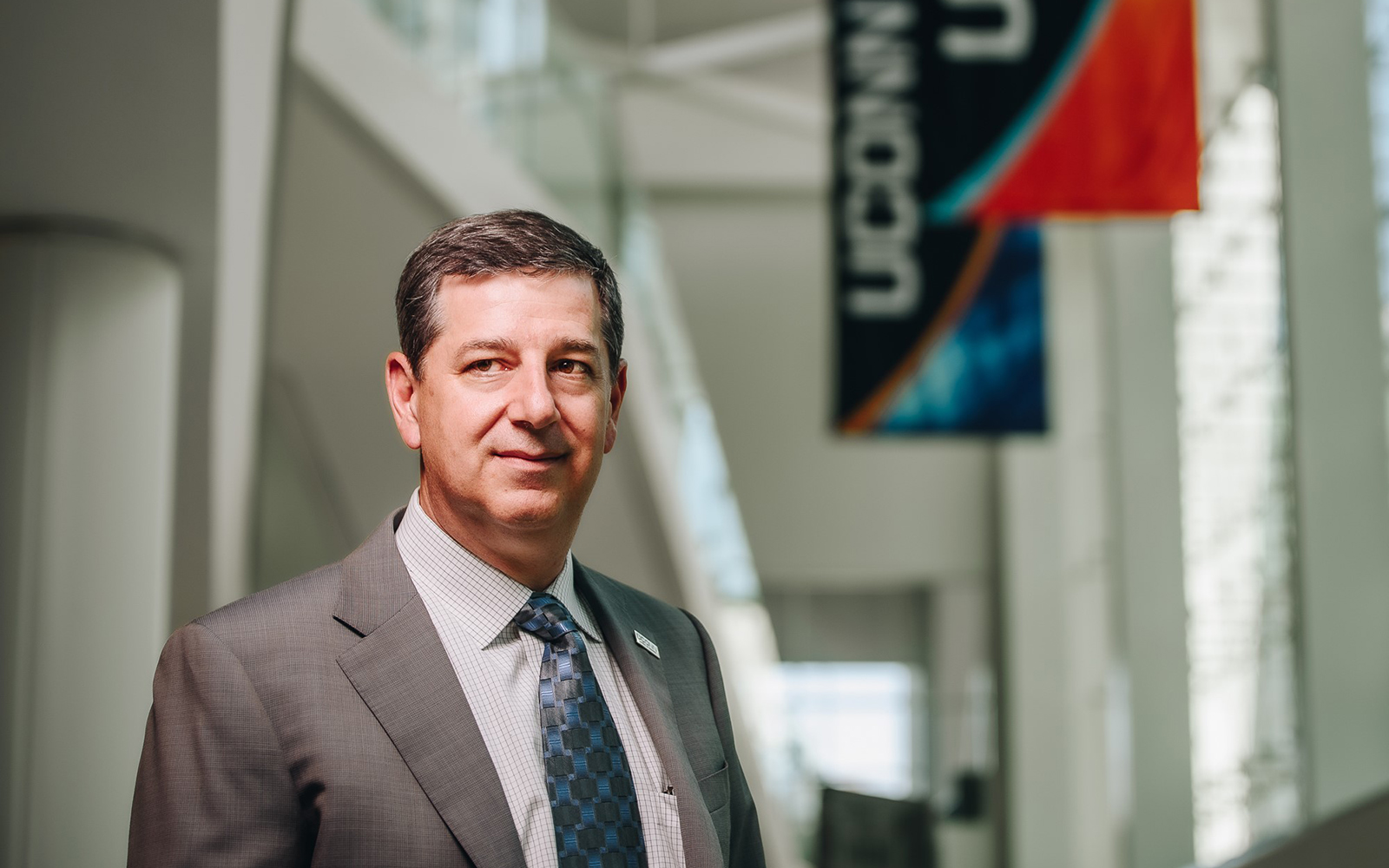 Photo of former Wal MArt CEO Bill Simon posing at UConn Stamford.