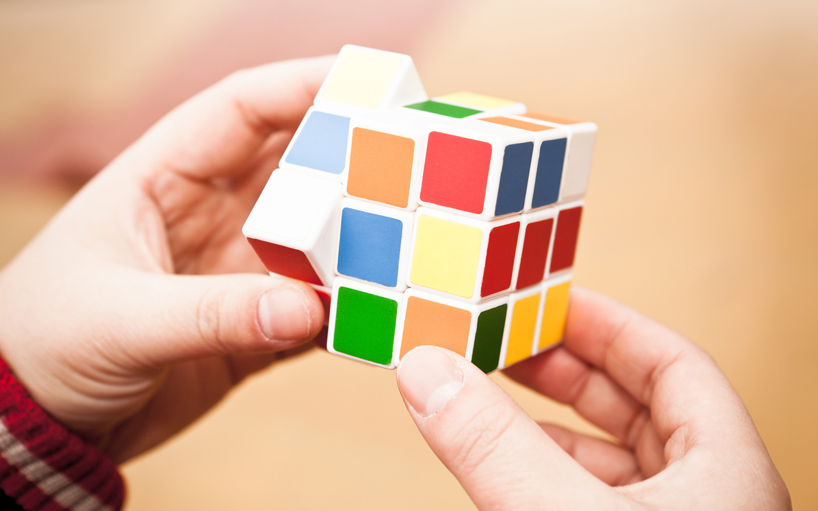 "Shanghai, China - Feb 12, 2012: Hands playing a Rubik's Cube game.Rubik's Cube is a 3D mechanical puzzle invented in 1974 by Hungarian sculptor and professor of architecture Erna Rubik"
