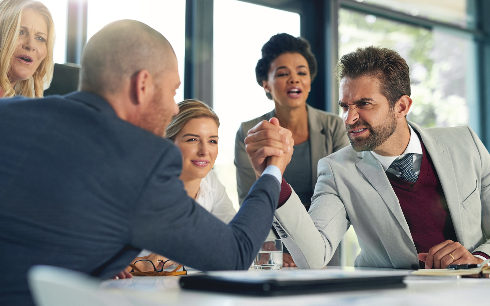 Cropped shot of businesspeople arm wrestling in an office