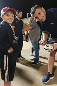 Tyler Davis '18 and young fan fan Jack Hanrahan during Davis's time as a Husky.  (Contributed Photo)