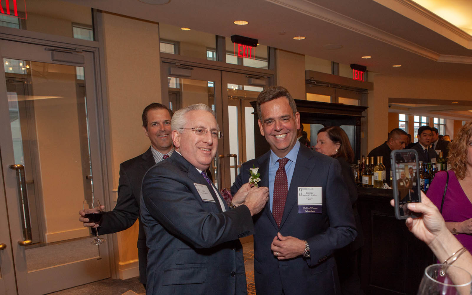 Geroge Barrios, right, at the 2019 School of Business Hall of Fame ceremony. Barrios spoke to EMBA students in Hartford, Conn. (Tom Hurlburt / UConn School of Business)