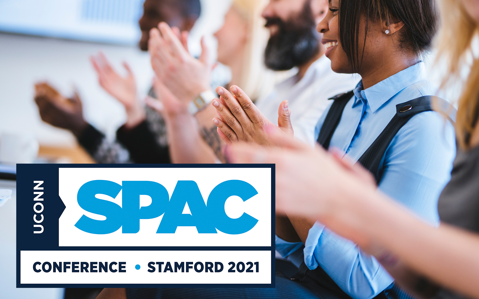 IMage of conference attendees applauding, SPAC conference logo is inset. 