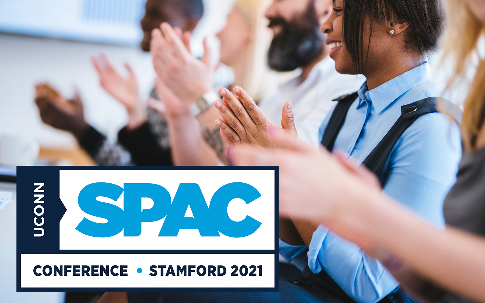 IMage of conference attendees applauding, SPAC conference logo is inset.