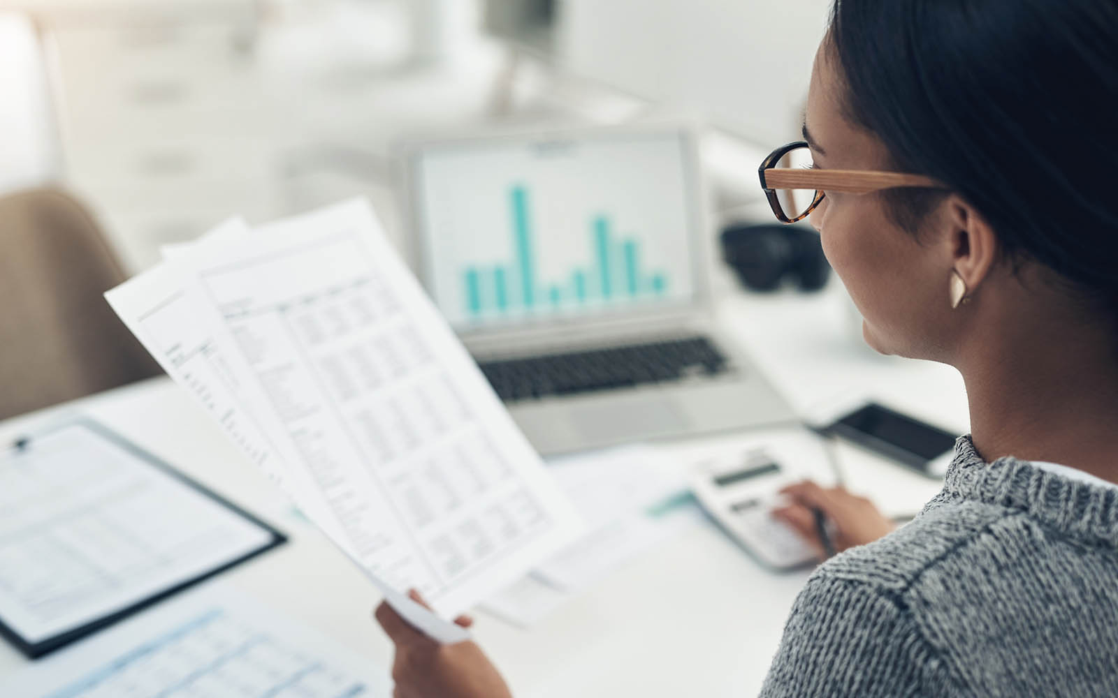Closeup shot of an unrecognisable businesswoman calculating finances in an office