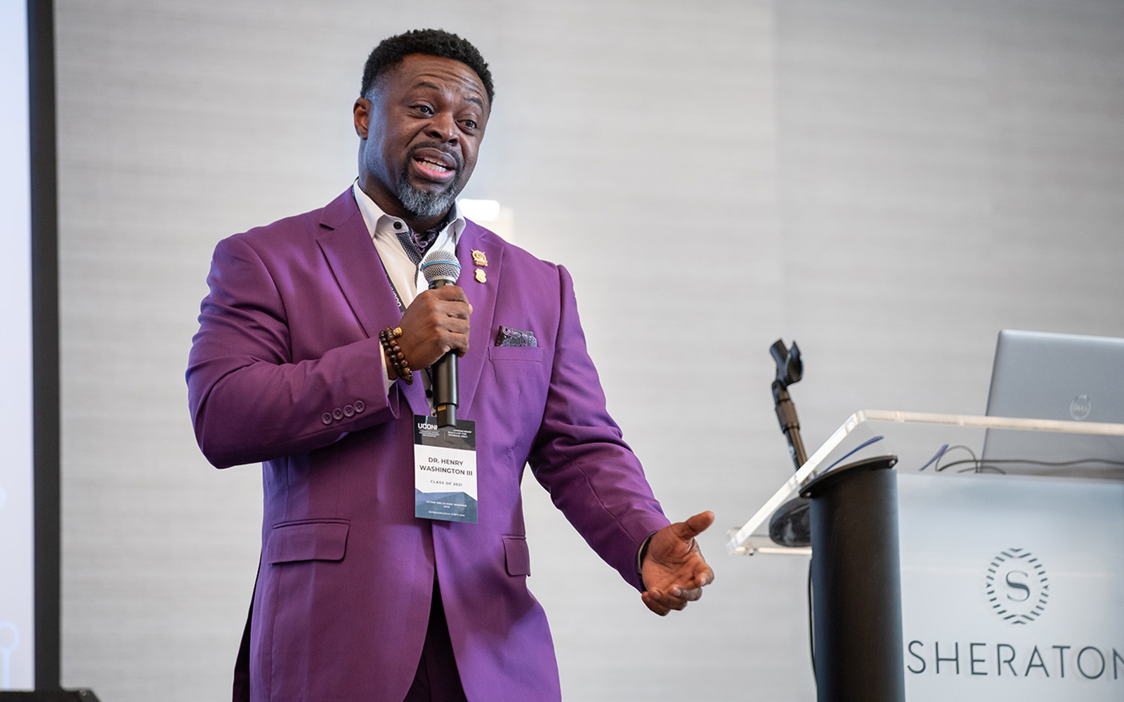 U.S. Army Major (Ret.) Henry H. Washington III ’21 EBV speaking into a microphone at a recent event.